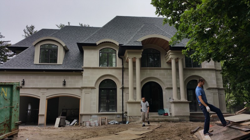 Limestone home with columned entry