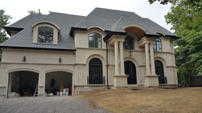 Limestone home with columned entry