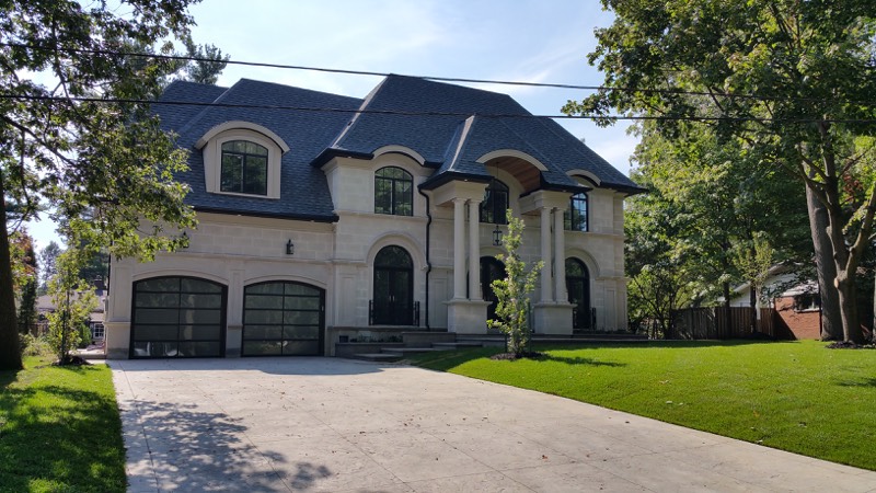 Limestone home with columned entry