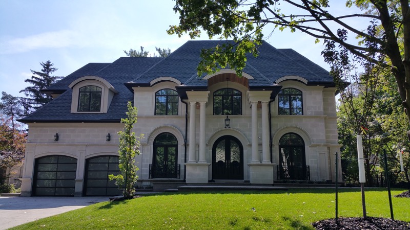 Limestone home with columned entry