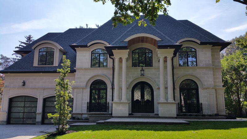 Limestone home with columned entry