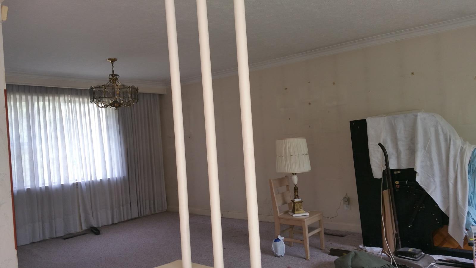 Living room before and after removing a dividing wall and opening the stairwell