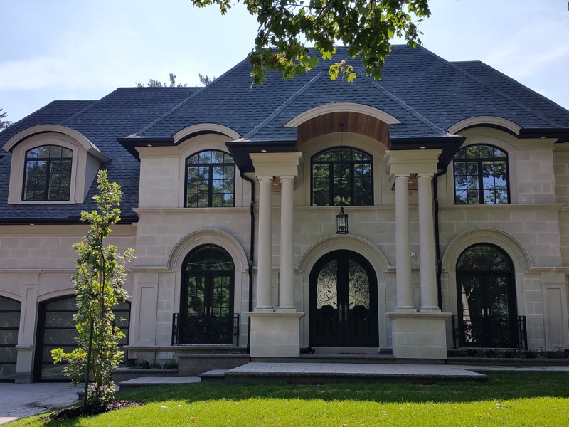 Limestone home with columned entry